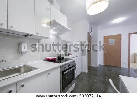 Small, white modern kitchen interior design in small apartment