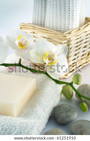 White towels and soap, orchid, on white background