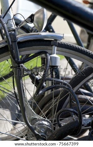 Bikes locked with heavy steel chain close-up