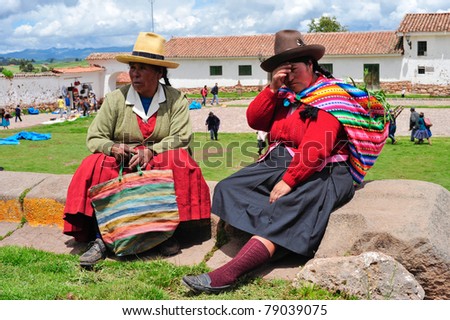 PISAC, PERU, SOUTH AMERICA - MARCH 07: Tired women are taking brake before sunday mess on March 07, 2010 in Pisac, peru, south america.