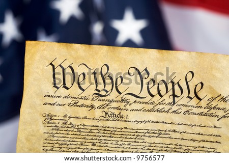 United States Constitution with Flag in background