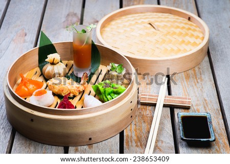Dimsum Hagao in chinese bamboo basket. Gyoza on a wooden table in a restaurant