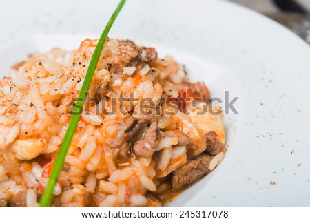 Traditional spanish dish rice with chicken seafood and meat close up