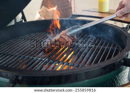 stages of cooking steak on the grill - ready piece of grilled steak with a grill in the background focus on different parts of the meat