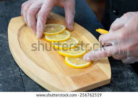 stages of cooking salmon on the grill - chef decorates a wooden platter for serving filet