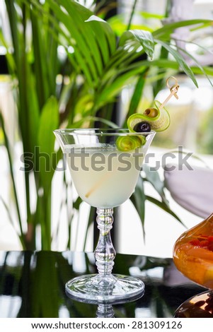 bright glasses with cold alcoholic cocktail on a table in a restaurant with creative decoration. soft focus