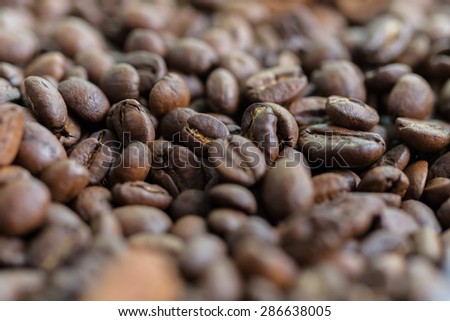 creative composition of roasted coffee beans on a table with a nice bokeh in the background. soft focus.