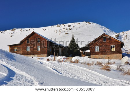 Winter, mountains, alpine chalet in snow, and blue sky