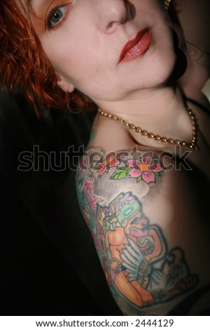 stock photo : mystical shoulder tattoo detail on black background