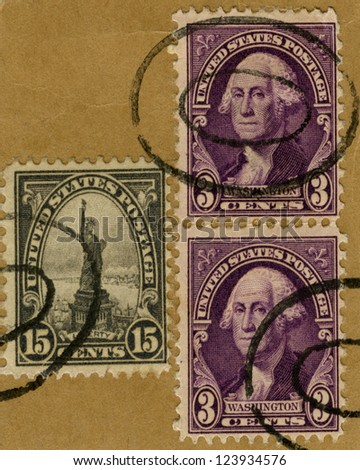 A collection of vintage US stamps depicting Statue of Liberty and US President George Washington