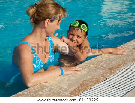 Mother and her son in the swimming pool. Swimming lessons.