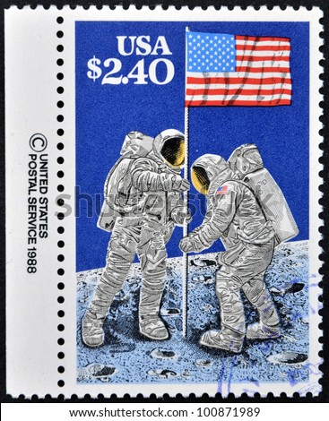 UNITED STATES OF AMERICA - CIRCA 1988: A stamp printed in USA shows Astronauts planting Flag on Moon, 20th Anniversary of First Manned Moon Landing, circa 1988