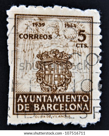 SPAIN - CIRCA 1944: stamp printed in Spain  commemorating the council  Barcelona, 1939-1944, shows Barcelona ancient shield with two sticks of gules, the cross of St. George and the crown. circa 1944