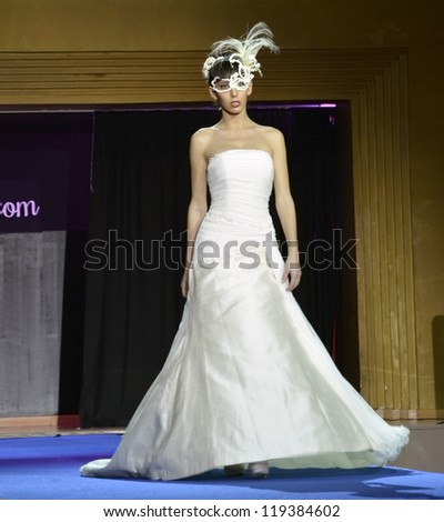 GRANADA, SPAIN - NOVEMBER 17: Model with wedding dress and mask walks the catwalk at the First Bridal Fair Granada, on November 17, 2012 in Granada, Spain