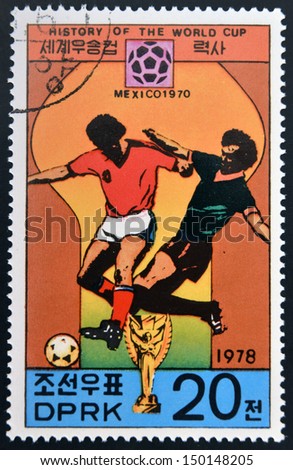 KOREA - CIRCA 1978: A Stamp printed in North Korea shows the Soccer players, Cup and Glob with the inscription 