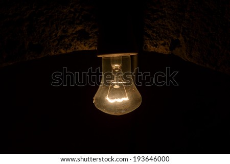 Old dusty light bulb in the dark