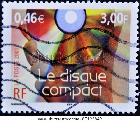 FRANCE - CIRCA 2001: A stamp printed in France shows hand holding a compact disc, circa 2001
