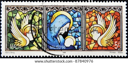 MALTA - CIRCA 1996: A stamp printed in Malta shows drawing of a window with the virgin and the child and the angels, circa 1996