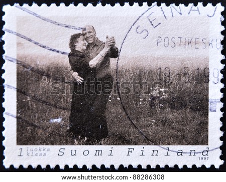 FINLAND - CIRCA 1997: A stamp printed in Finland shows an older couple dancing in the field, circa 1997