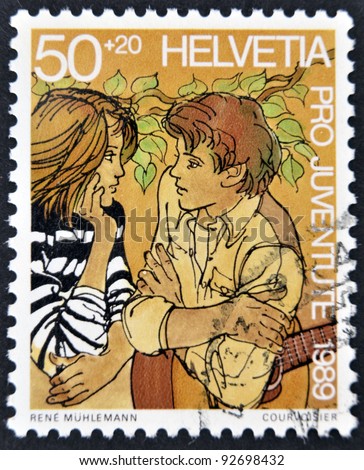 SWITZERLAND - CIRCA 1989: A stamp printed in Switzerland shows a young couple in love, circa 1989