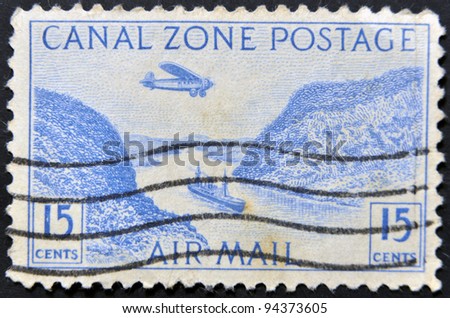 PANAMA CANAL ZONE - CIRCA 1983: A stamp printed in Panama Canal Zone shows floating on the canal boat and airplane, circa 1983