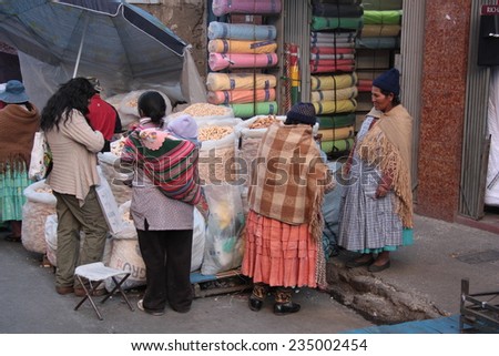 BOLIVIA, LA PAZ, 13 AUGUST 2013 - People buy food in a street of La Paz, Bolivia