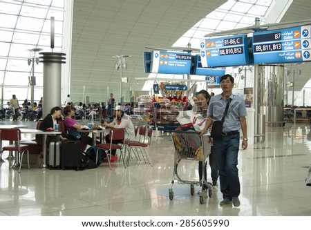 UNITED ARAB EMIRATES, DUBAI AIRPORT, 28 JULY 2014 - People in the waiting lounge of Dubai Airport terminal, United Arab Emirates