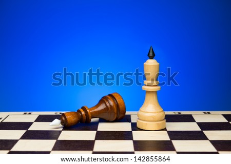 Two chess king. Black lost the tournament. Chess board and blue background