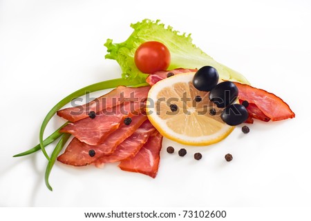Pieces of meat cuts with vegetables and spices on a white background