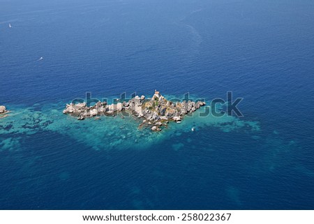 aerial view of the island with a chapel on the top front of the coast where the town of Petrovac, Montenegro