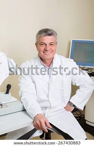 Optometry concept -  portrait of handsome elderly eye doctor