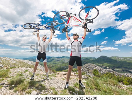 two cyclists overcome ascent of Mount celebrating victory