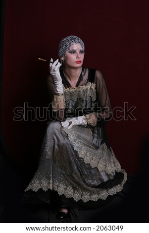 Lady l with a cigarette dressed in  style of the beginning of XX century