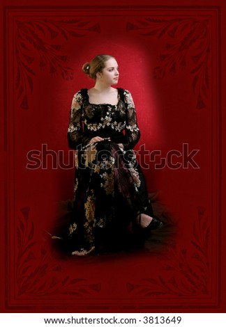 pretty young lady  in old time ball dress with black fan