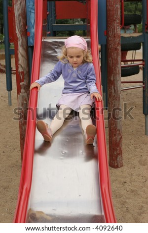 girl on the slide - outdoor activity in preschool