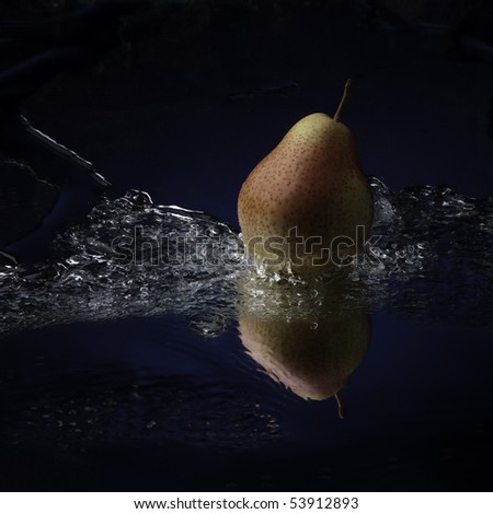 pear with teflection in water splash studio shot