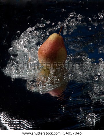 pear with reflection in water splash studio shot