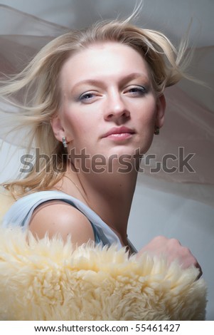 a well looking middle age lady with flying hair and fur