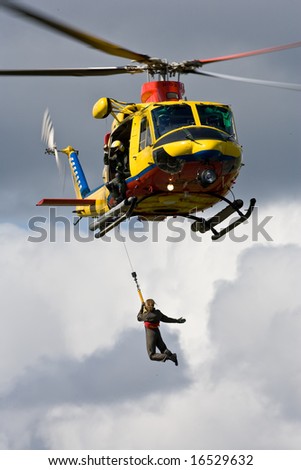 Person being winched up to an Air Sea Rescue helicopter