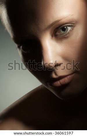 Beauty image of woman\'s face in dark shadows