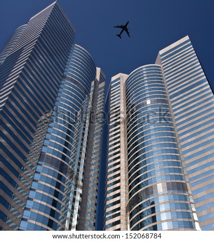 A low flying aircraft above the skyscrapers of the business district of Hong Kong