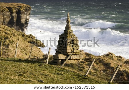 Rough seas near a cairn at Brough Head on the east coast of Scotland 10 mile south of John O\' Groats in northern Scotland.