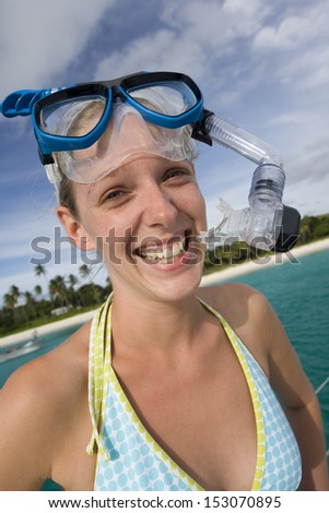 Girl in snorkel gear near a tropical beach on the South Pacific island of Fiji.