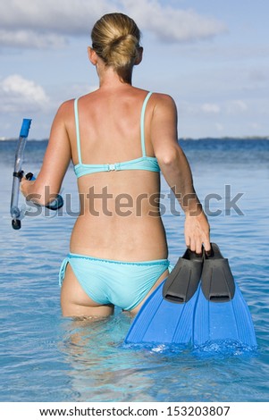 Young woman on a tropical vacation in the Cook Islands in the South Pacific.