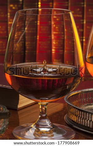 Brandy glasses (brandy snifter) in a gentleman\'s club. Brandy is a spirit produced by distilling wine. Often taken as an after-dinner drink.