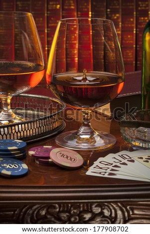 Brandy glasses (brandy snifter) in a gentleman\'s club. Brandy is a spirit produced by distilling wine. Often taken as an after-dinner drink.