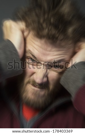 An angry man tearing his hair out