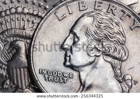 Close-up detail on a United States quarter dollar coin - In God we Trust - Liberty.