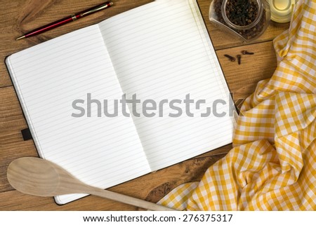 A Cooks Notebook on a farmhouse kitchen table - Space for Text
