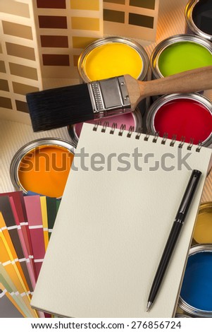 Painting and decorating - Paint tester pots, color charts and a notepad and pen - Space for text.
